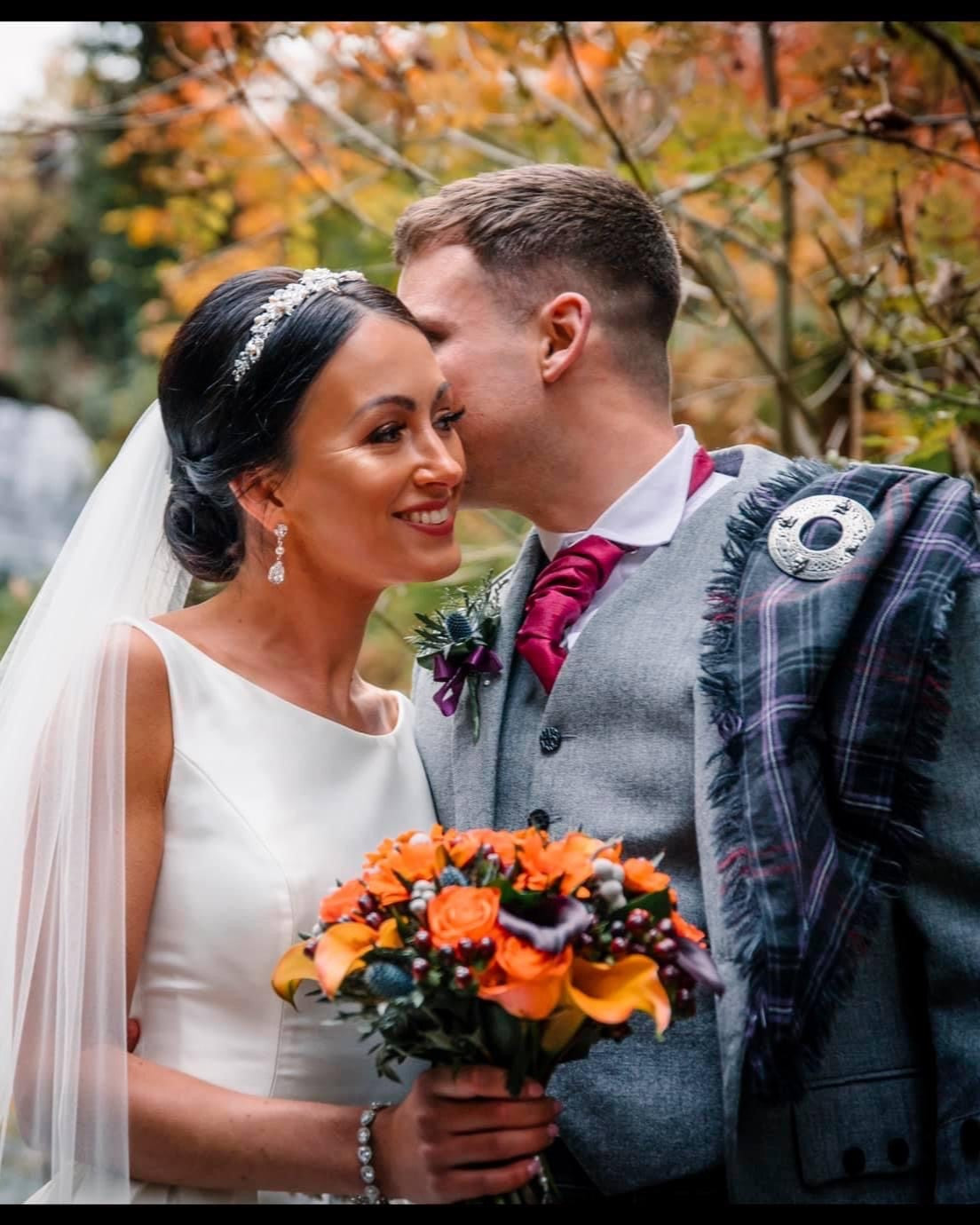 Autumnal bride bouquet sparkly bridal jewellery on bride with groom