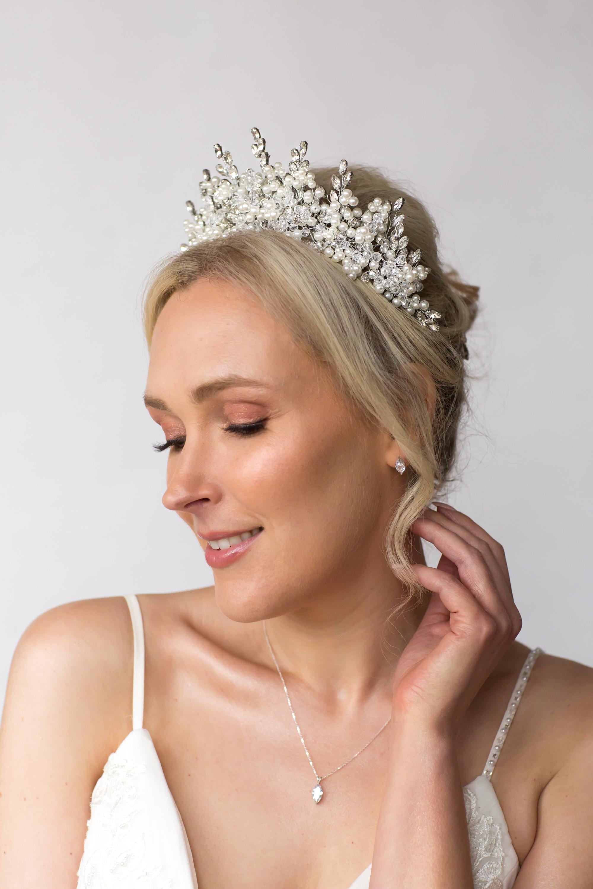 large bridal crown worn by bride and simple sterling silver wedding jewellery